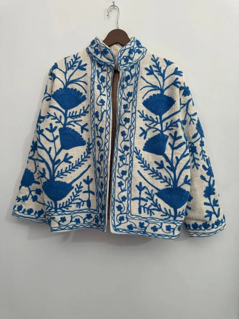 An ivory Suzani jacket with deep blue floral embroidery