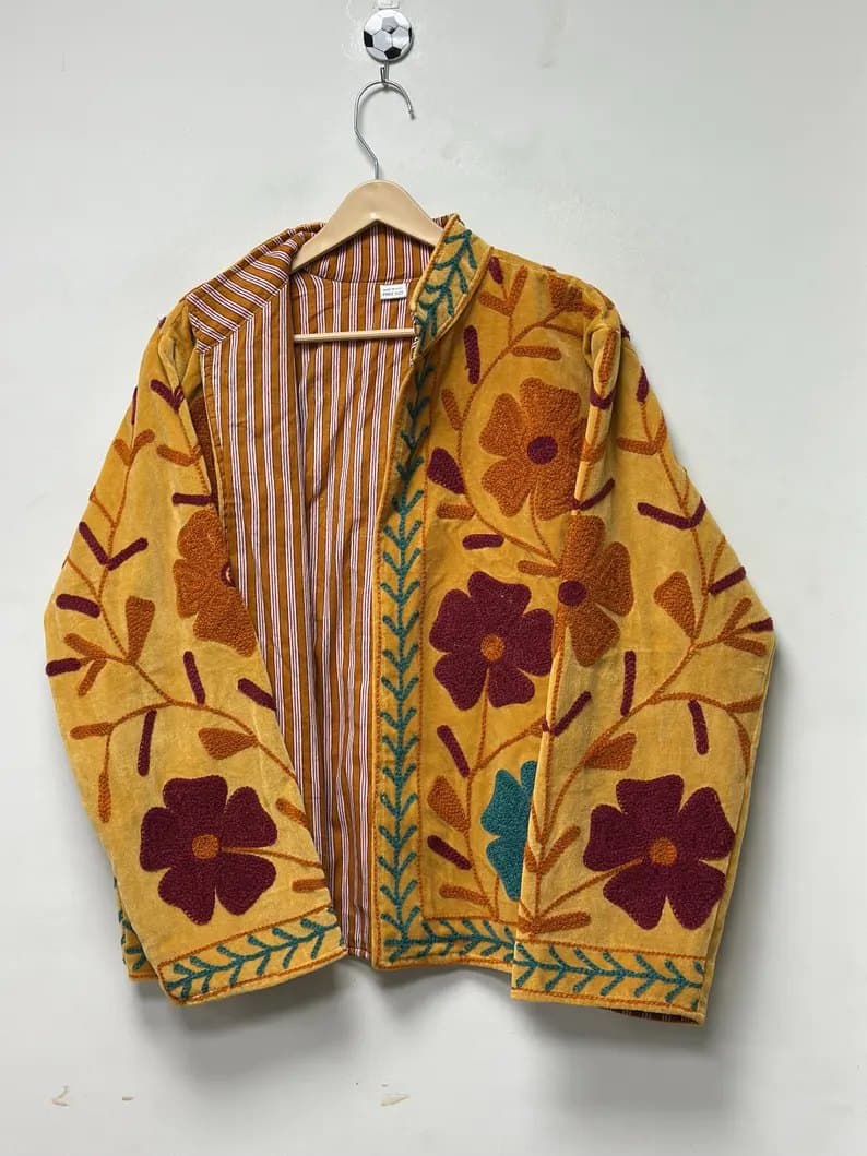 An ochre Suzani jacket with deep maroon flowers and a striped lining