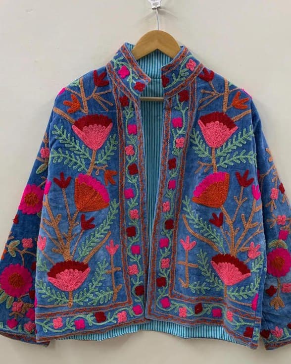 Back view of a navy Suzani jacket embroidered with turquoise hares