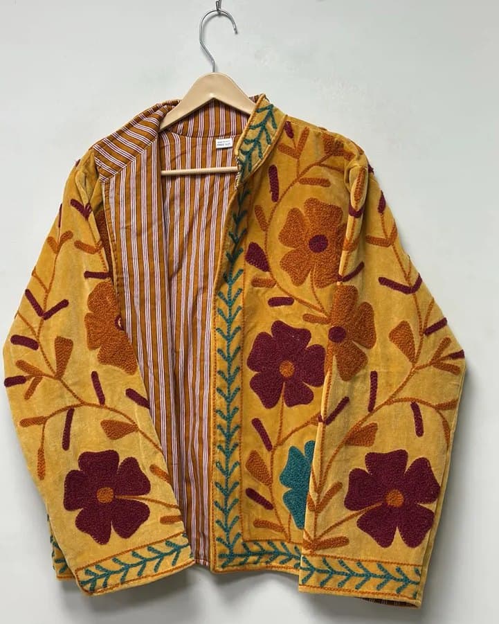 A ochre Suzani jacket with deep maroon flowers, shown open, front panel detail