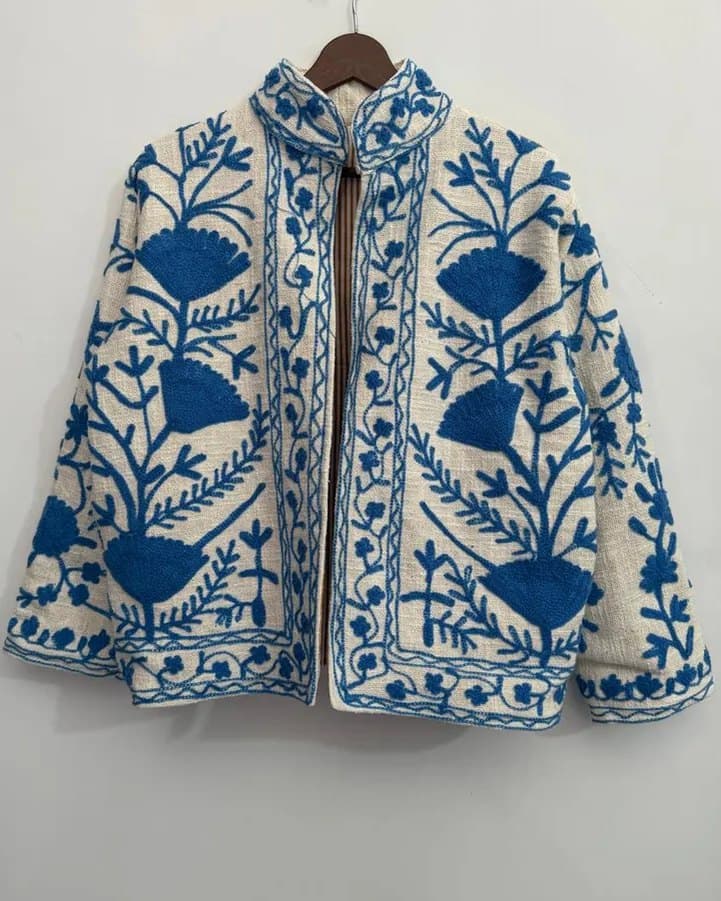 A ivory Suzani jacket with deep blue floral embroidery, front panel and collar detail