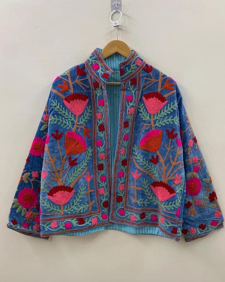 A cornflower blue Suzani jacket with pink and red floral embroidery, front panel and collar detail