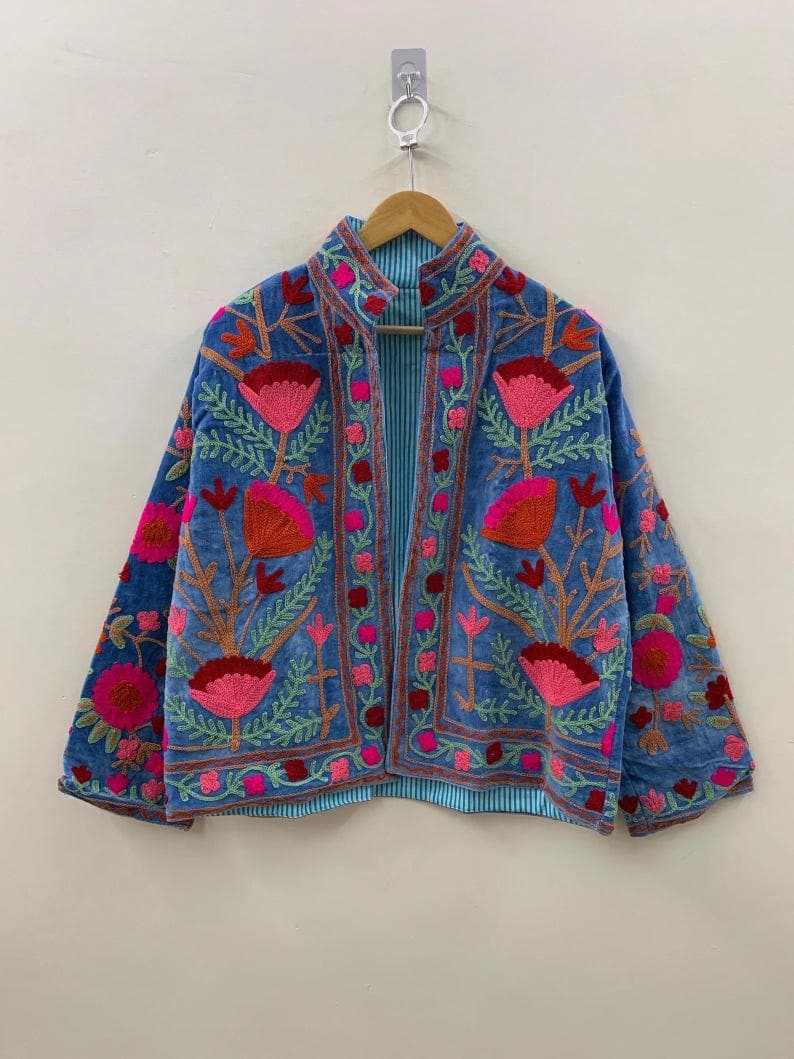 A cornflower blue Suzani jacket with pink and red floral embroidery