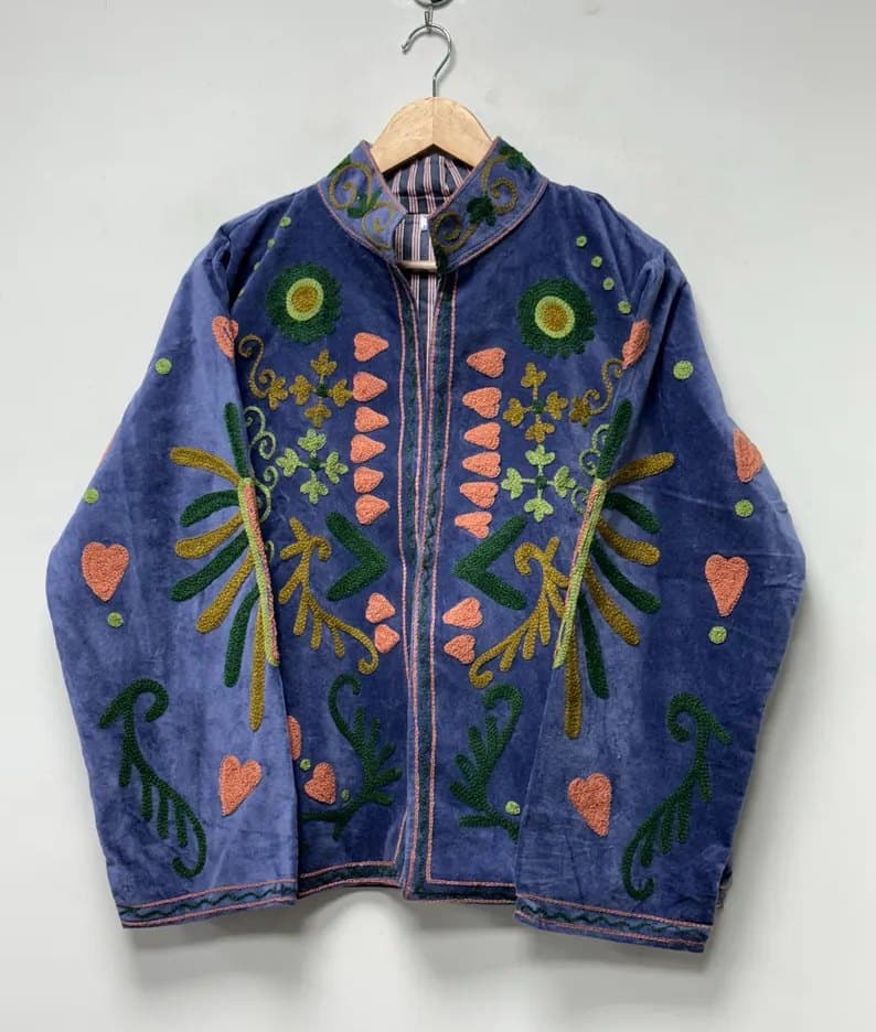 A periwinkle velvet Suzani jacket with coral and green motifs